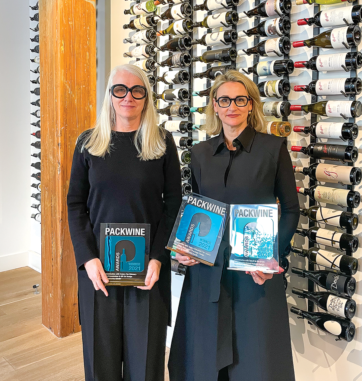 Denomination's Global Creative Director Margaret Nolan (left) and CEO Rowena Curlewis (right) from Denomination, with their three PACKWINE Design Awards trophies.